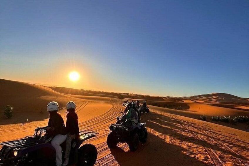 Off-road vehicles on a desert trail with a clear sky. 1