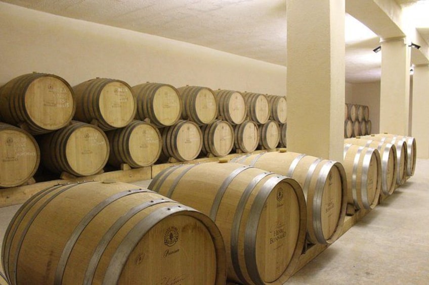 Wooden wine barrels stacked in a warehouse. 3