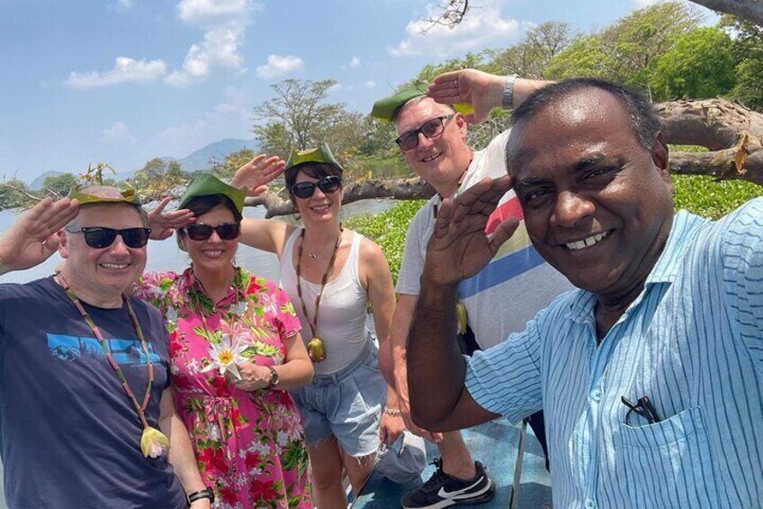 A group of people posing by a river with trees and a clear sky in the background. 5