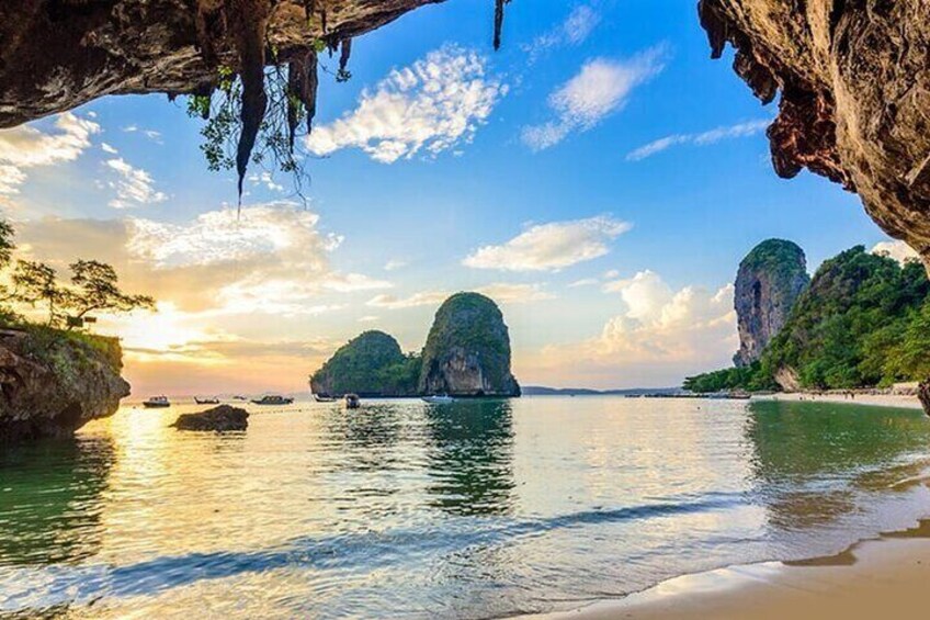 A coastal scene with clear water, rocky formations, and a sunset. 2