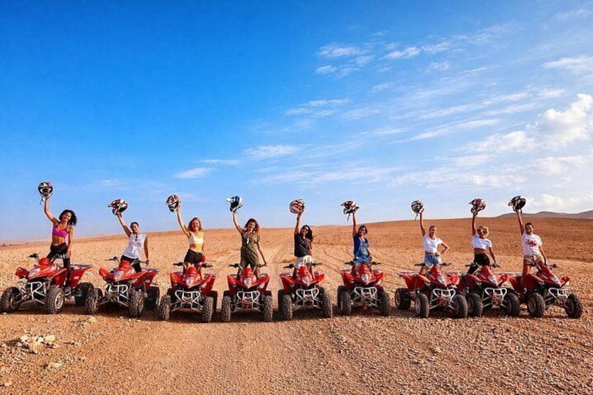 A group of people on quad bikes in a desert landscape. 2