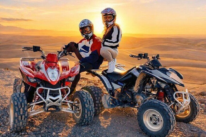 Two ATVs on a rocky terrain with a sunset in the background. 3