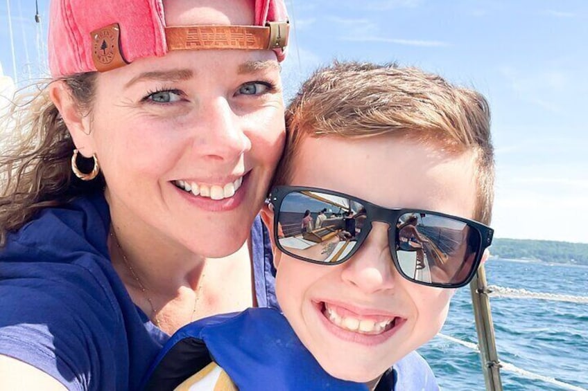 Two people on a boat with the ocean in the background. 2