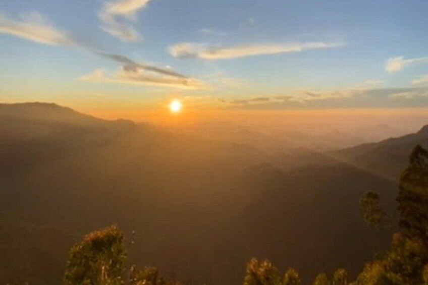 A mountain landscape at sunrise with the sun low on the horizon. 5