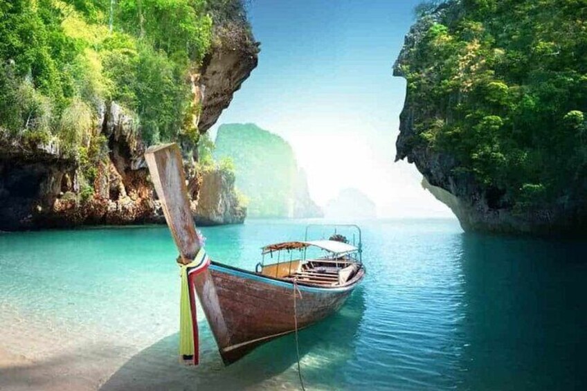 A traditional wooden boat docked at a calm river with lush greenery and rocky cliffs in the background. 2