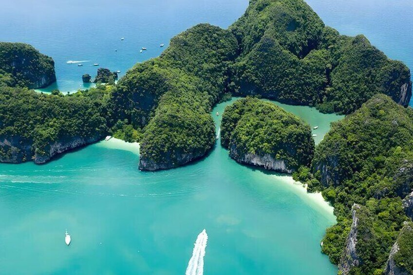 An aerial view of a cluster of lush green islands surrounded by turquoise waters. 4
