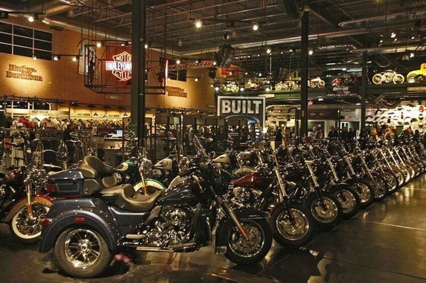A motorcycle showroom with rows of motorcycles on display. 2