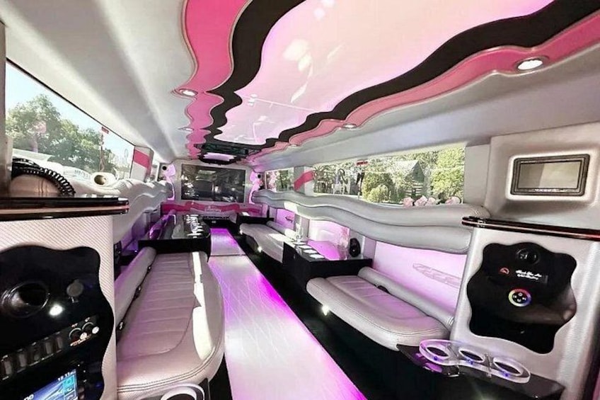 A luxurious interior with plush seating, a central entertainment system, and ambient lighting. 5