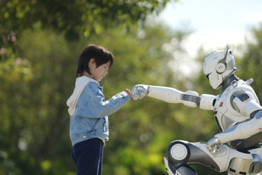 A person in a denim jacket and a robot with a white and gray body. 4