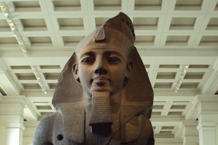 A large ancient Egyptian sarcophagus with a prominent cobra head. 5