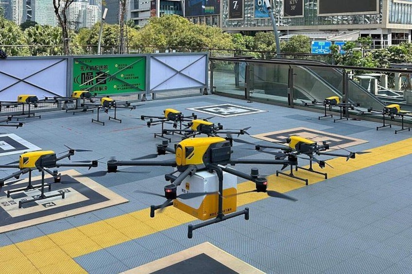 A rooftop with multiple drones parked on a patterned surface. 2