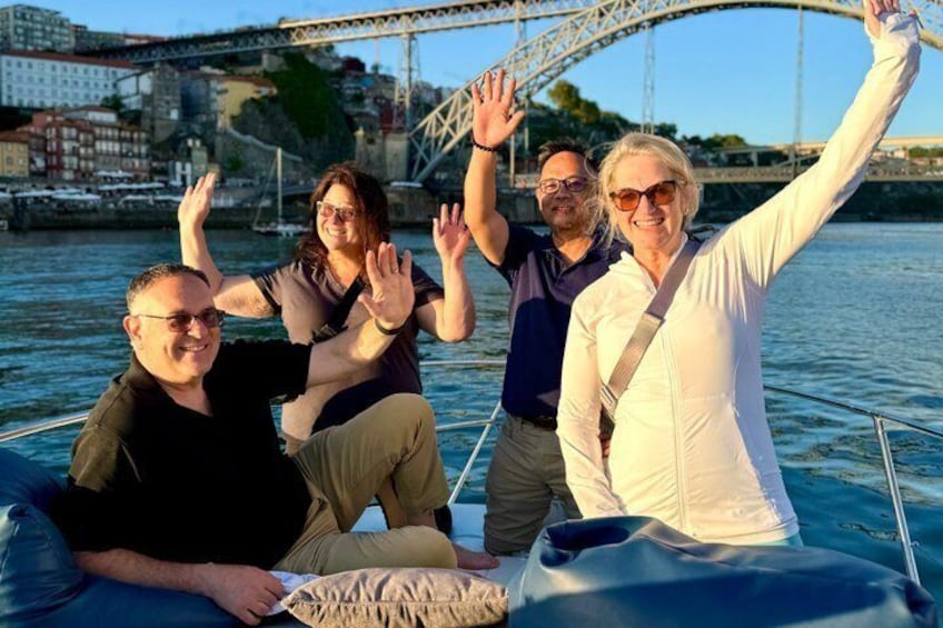 A group of people on a boat with a bridge in the background. 3