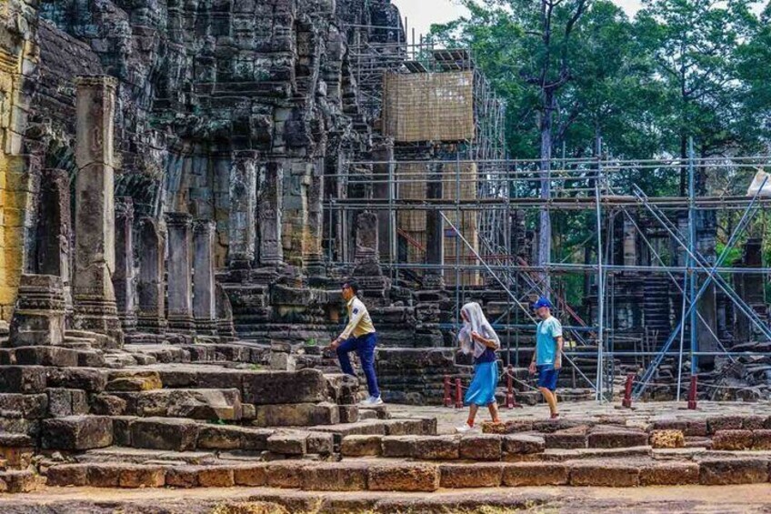 Ancient stone steps leading up to a temple with scaffolding. 3