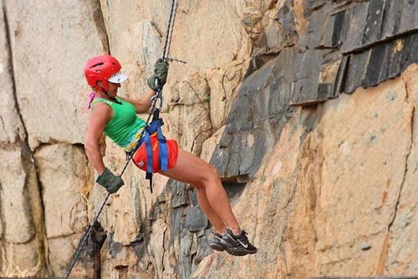 A person rock climbing on a rocky cliff. 2