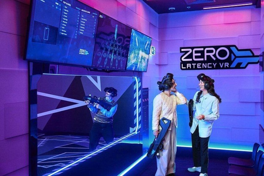 A VR gaming setup with multiple screens and a 'ZERO LATENCY VR' sign. 1