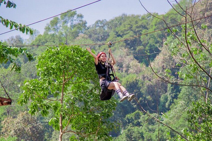 A person zip-lining through a forested area. 3