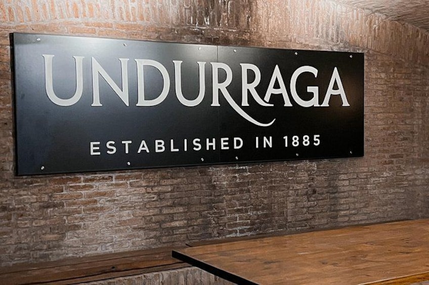 A sign with the text 'UNDURRAGA ESTABLISHED IN 1885' mounted on a brick wall. 5
