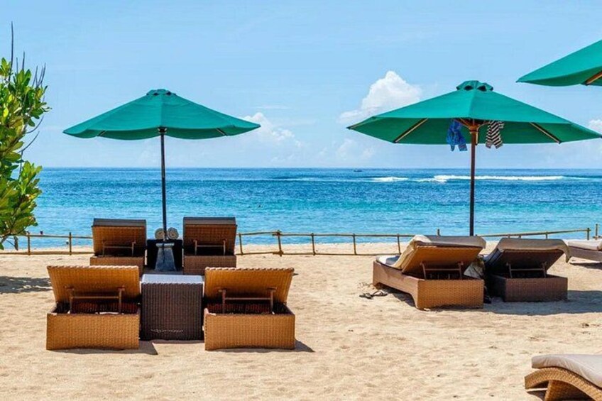 A beach with lounge chairs and umbrellas. 5