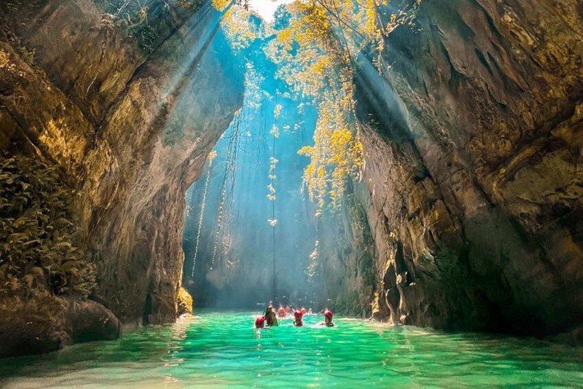 A river through a rocky canyon with sunlight streaming through. 2