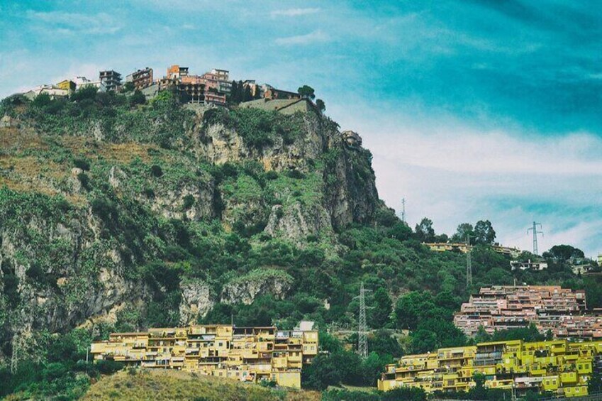 A mountainous village with buildings on a cliff. 3