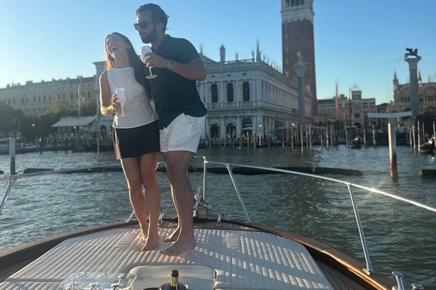 A couple on a boat with a historic building in the background. 2