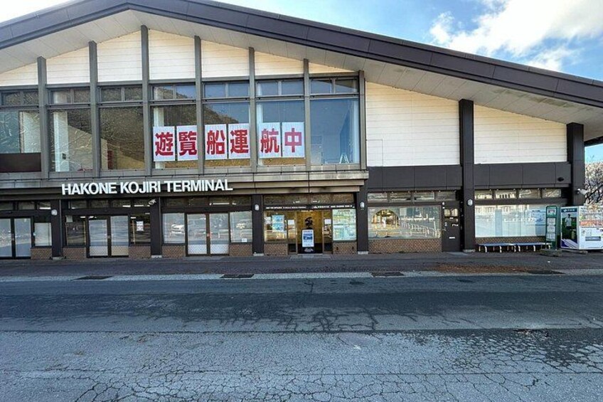 Hakone Kojiri Terminal with a large glass facade and signage in Japanese. 3
