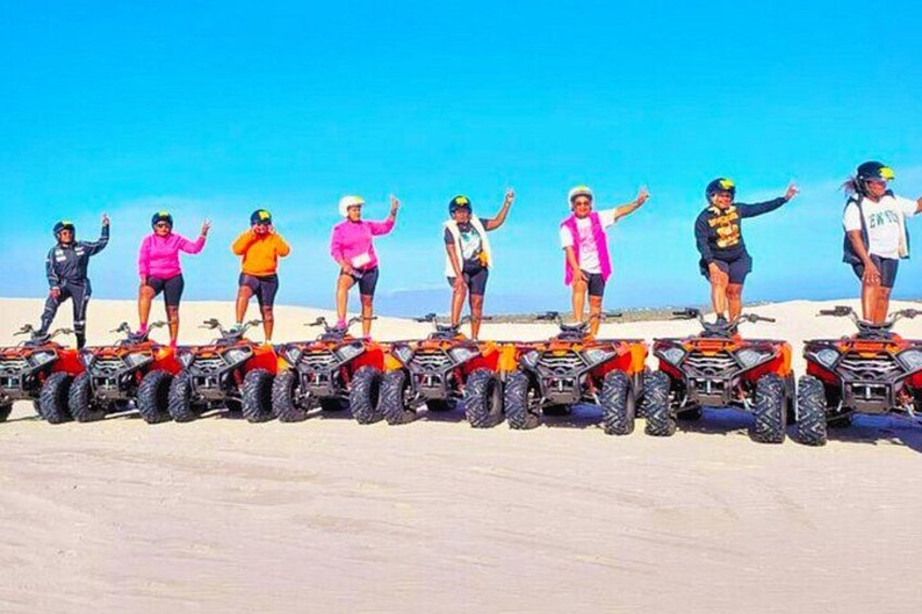 A group of people on ATVs in a desert landscape. 2