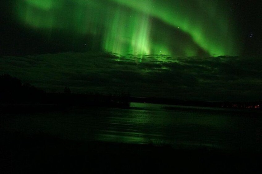 The Northern Lights over a body of water at night. 5