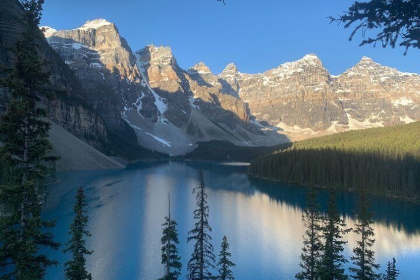 A mountain lake surrounded by forest and mountains. 1