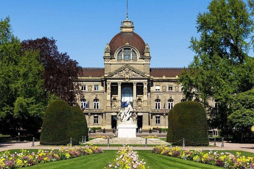 A grand building with a dome, statues, and a well-maintained garden. 3
