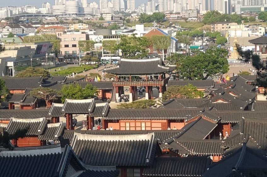 Traditional Korean architecture with tiled roofs and wooden structures. 4