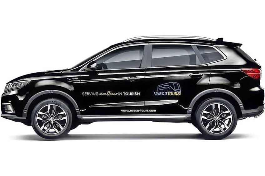 Un SUV negro con la leyenda 'SERVING excellence in tourism' y el logotipo 'MASCO TOURS'. 5