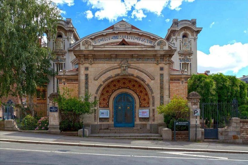 A historic building with a blue door, arched entrance, and decorative stonework. 4