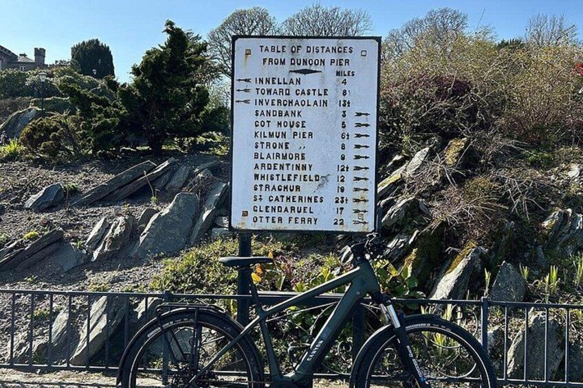 A sign listing distances from Quondon Pier to various locations. 2
