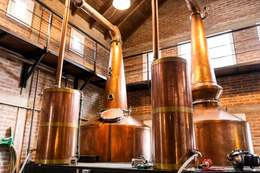 Copper distillation columns in a brick-walled industrial setting. 3
