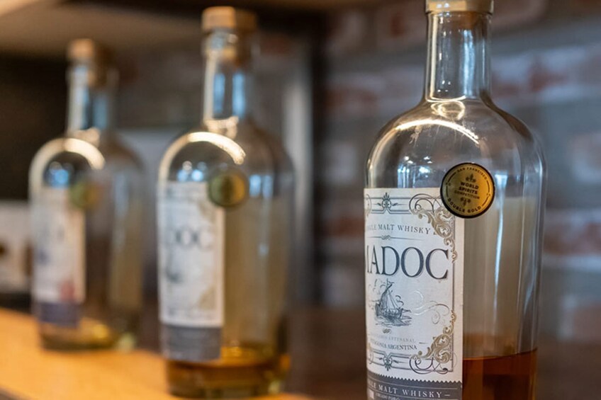 A row of bottles of Ladoc malt whisky. 5
