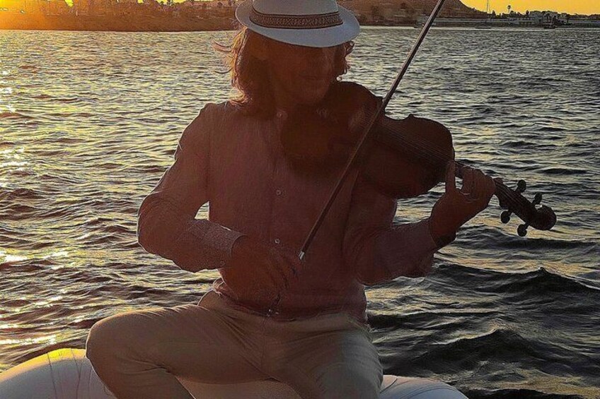 A person playing a violin on a boat. 3