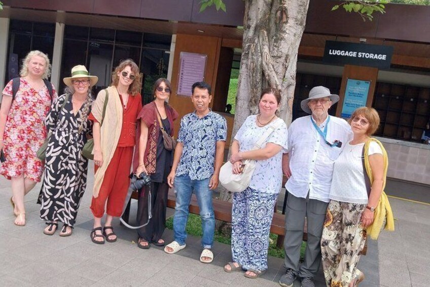 A group of people standing in front of a building with a sign that reads 'LUGGAGE STORAGE.' 3