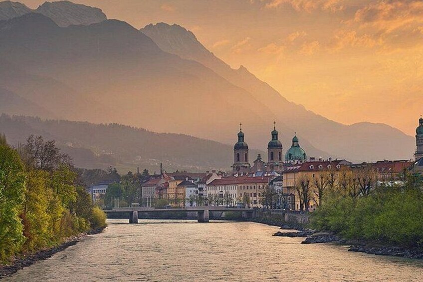 A river with buildings and mountains in the background. 5