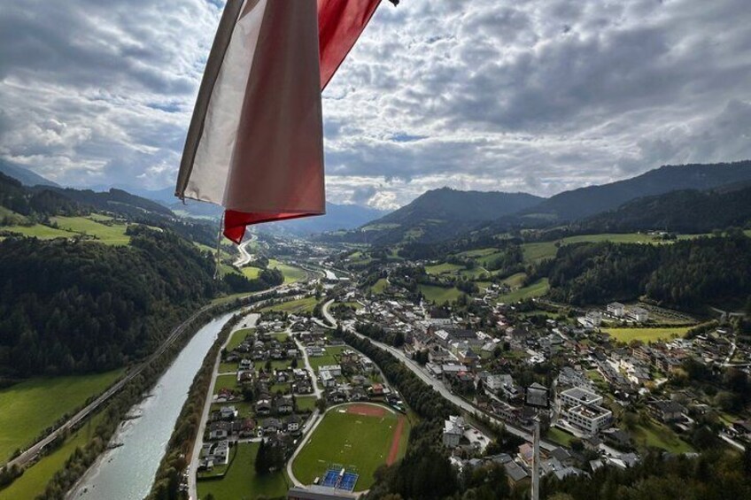 An aerial view of a town with a river, surrounded by mountains and greenery. 2