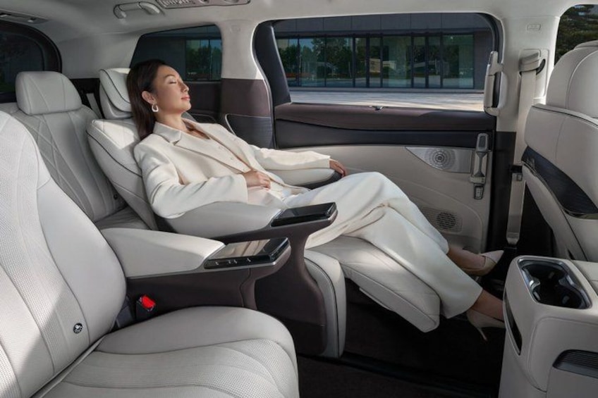 A luxury car interior with leather seats, a sunroof, and a center console. 2