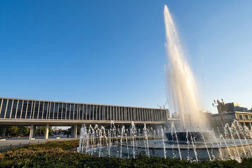 A modern building with a water fountain in front. 4