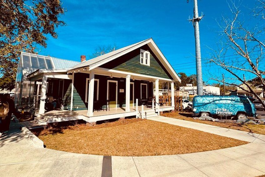 A house with a green roof, a covered porch, and a blue van parked in front. 4