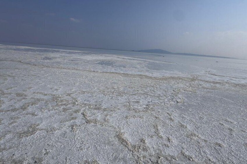A salt flat with a distant mountain range. 1