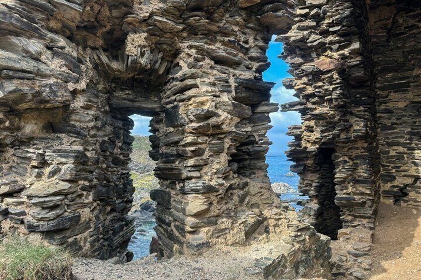 A natural rock formation with a narrow passageway. 3