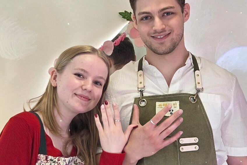 Two people in a kitchen, one wearing a chef's apron. 4
