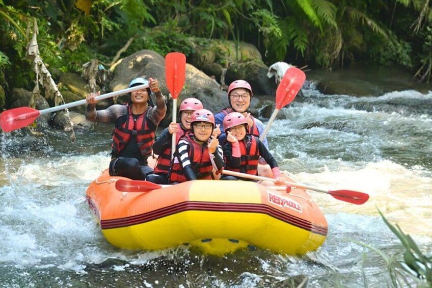 A group of people in a yellow and orange raft navigating a river. 3