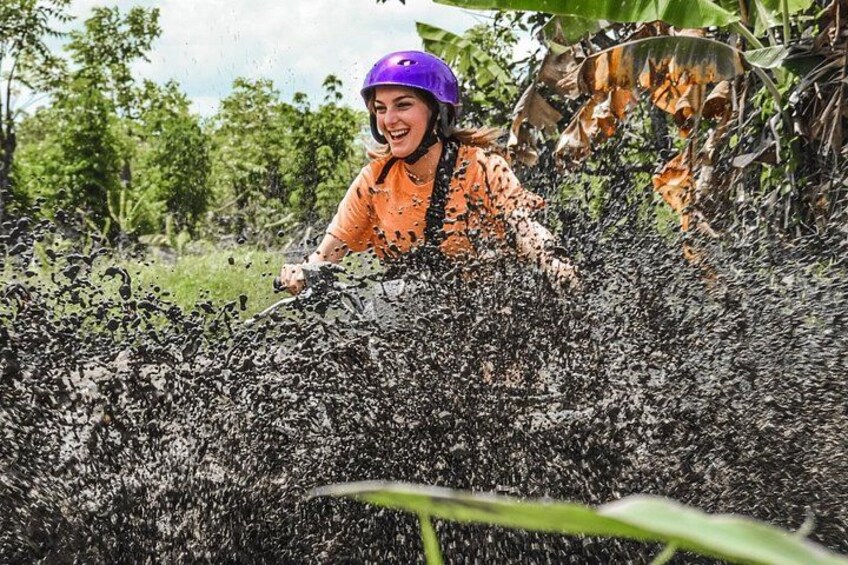A person in a helmet and orange shirt amidst dense foliage, possibly engaged in an outdoor activity. 1