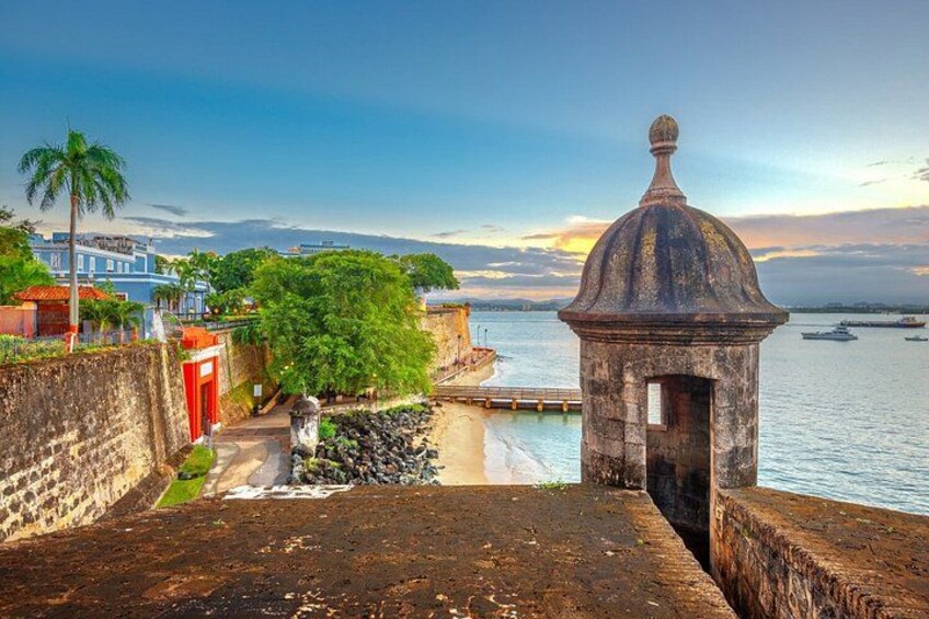 A coastal fortification with a dome, a beach, and a clear sky. 3