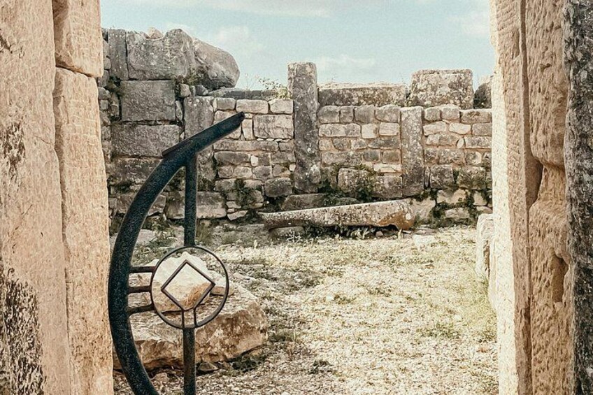 An ancient stone wall with a metal gate. 4